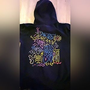 A black hoodie with multiple color designs.